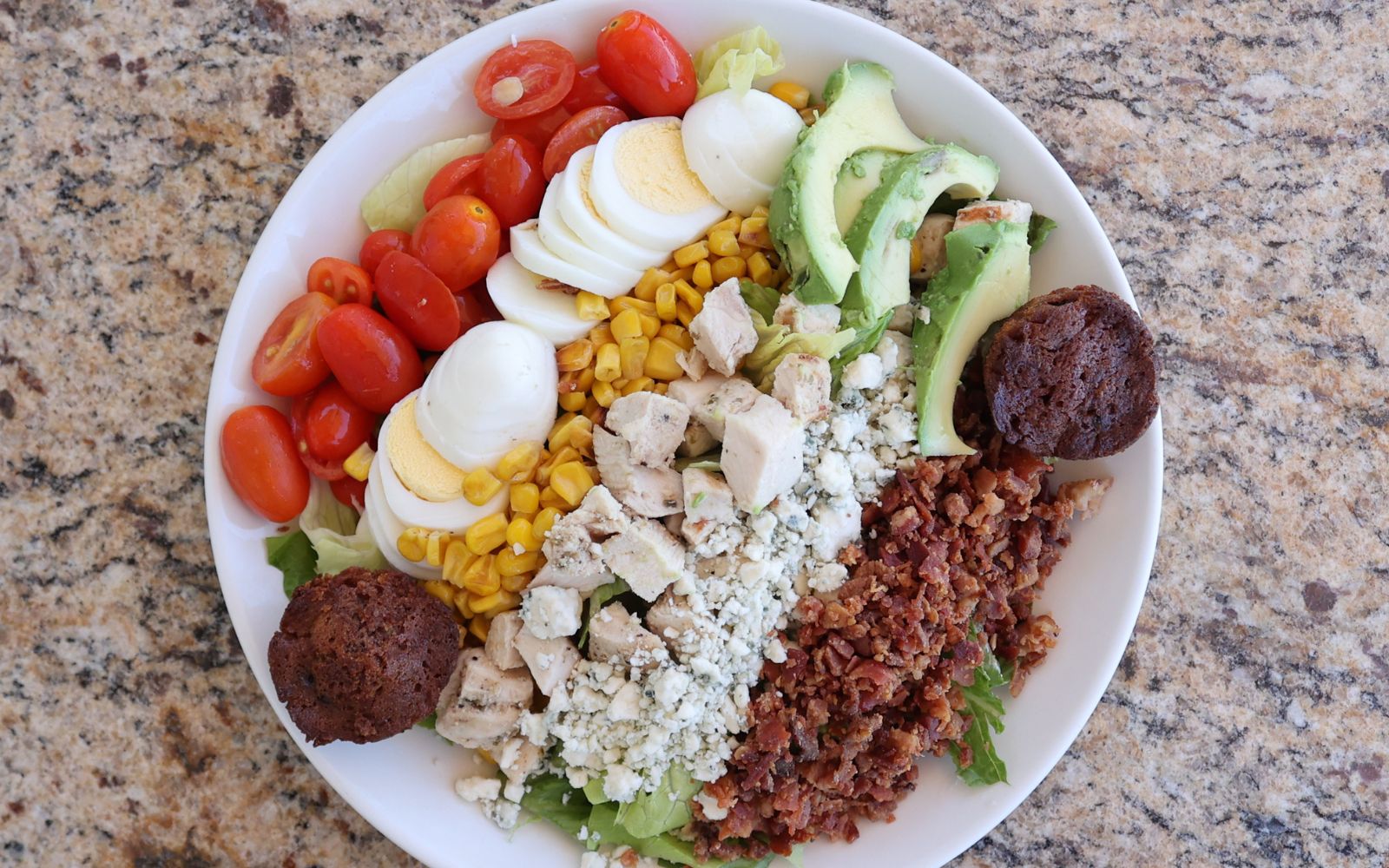 lunch plate of grilled chicken over salad